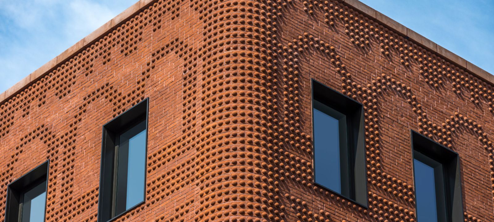 Facade of an unfinished two-story house with no red brick windows