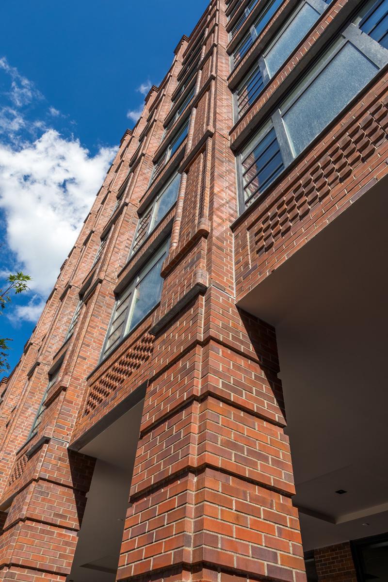 Image of the red bricked exterior of the Morgan Parc @ Village Green building