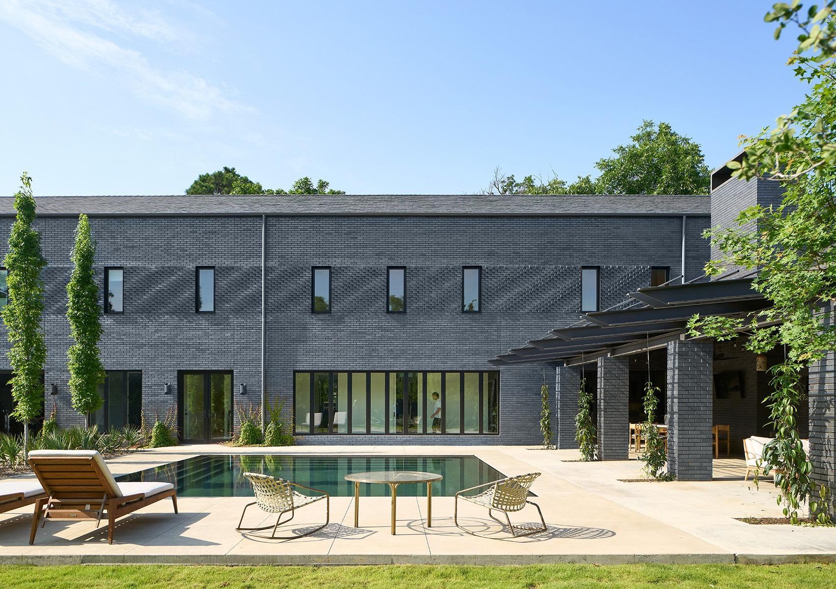 The dark brick exterior lends modern styling to the Robin Road Residence
